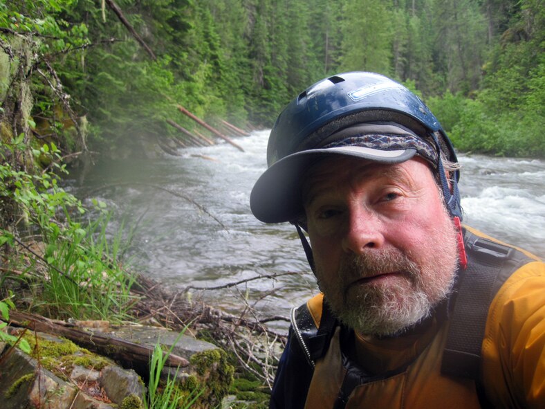 Bart Rayniak gets rescued by Airmen from Fairchild Air Force Base, Wash., when he was kayaking where Marble Creek flows into the St. Joe’s River, Wash., June 13, 2014. Rayniak was kayaking when his board flipped over, ejecting him into the cold water. (Courtesy photo)