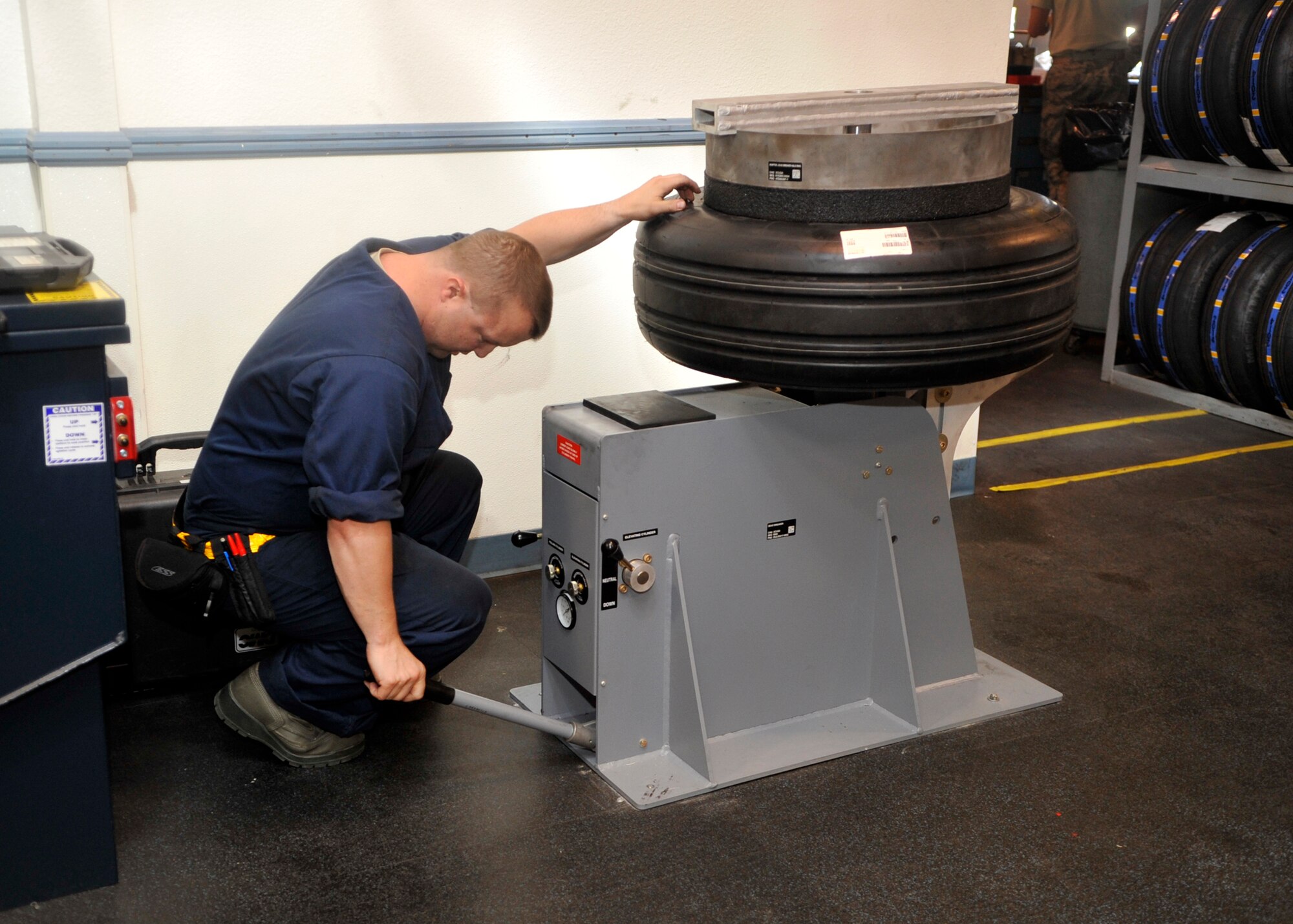 Millett calibrates a machine that helps the shop maintain and repair tires for the F-16 and F-35. (U.S. Air Force photo/Senior Airman Marcy Copeland)