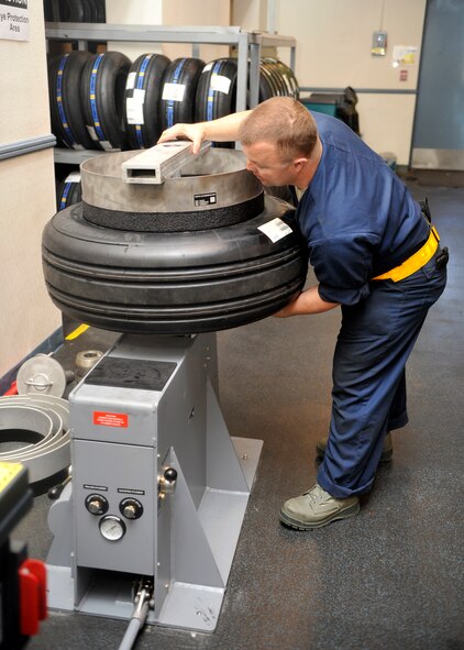Staff Sgt. Jason Millett, 56th EMS Wheel and Tire Shop crew chief, preps a tire for repair. Until more F-35s arrive on base, the wheel and tire shop maintain only two tires for the jet. The shop is also responsible for maintaining and repairing tires for the F-16 Fighting Falcon. (U.S. Air Force photo/Senior Airman Marcy Copeland)