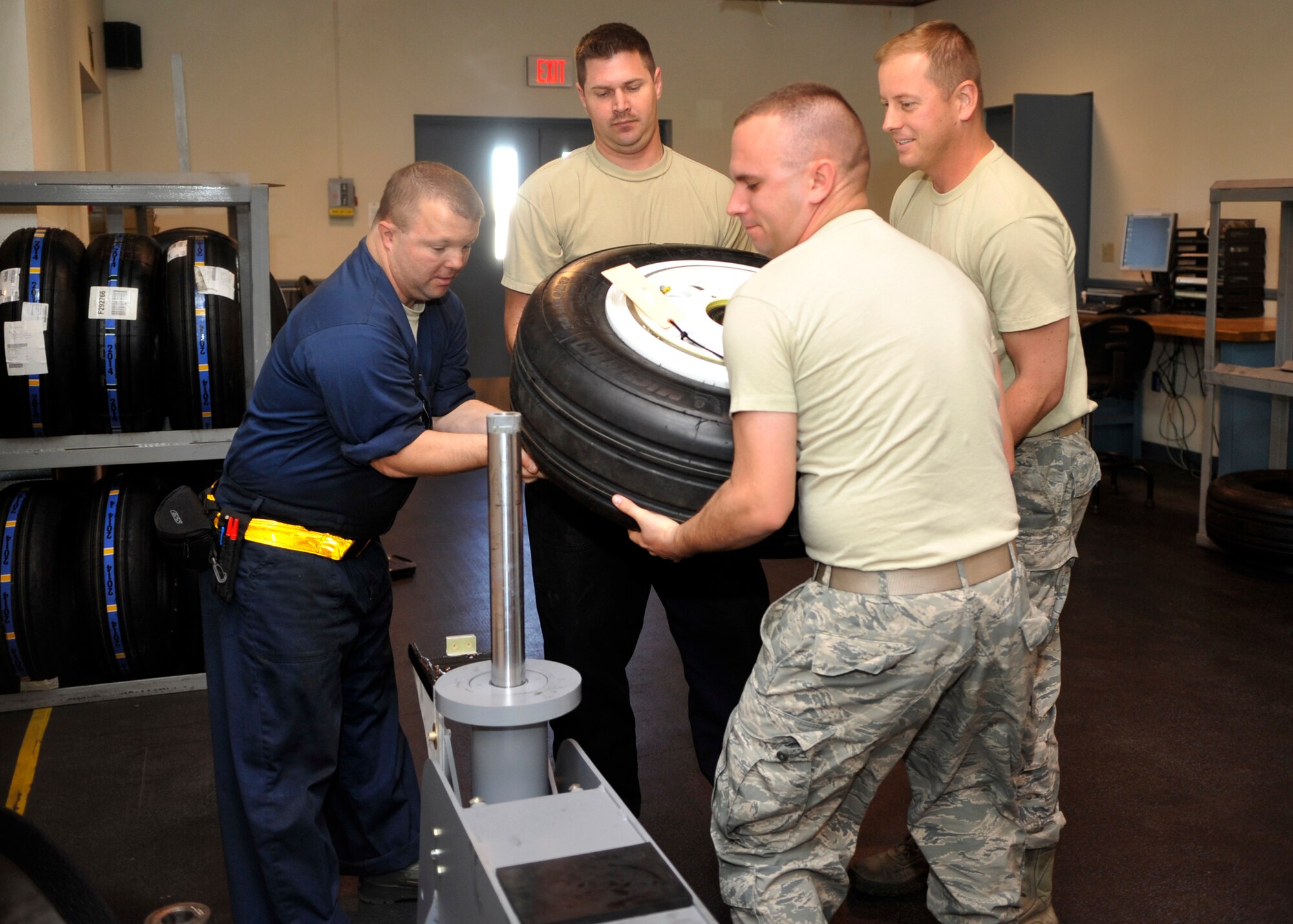 Members of the 56th Equipment Maintenance Squadron Wheel and Tire Shop lift an F-35 Lightning II tire for repair. With the F-35 on base, the 56th EMS Wheel and Tire Shop is training on tire maintenance and repair for the F-35. (U.S. Air Force photo/Senior Airman Marcy Copeland)