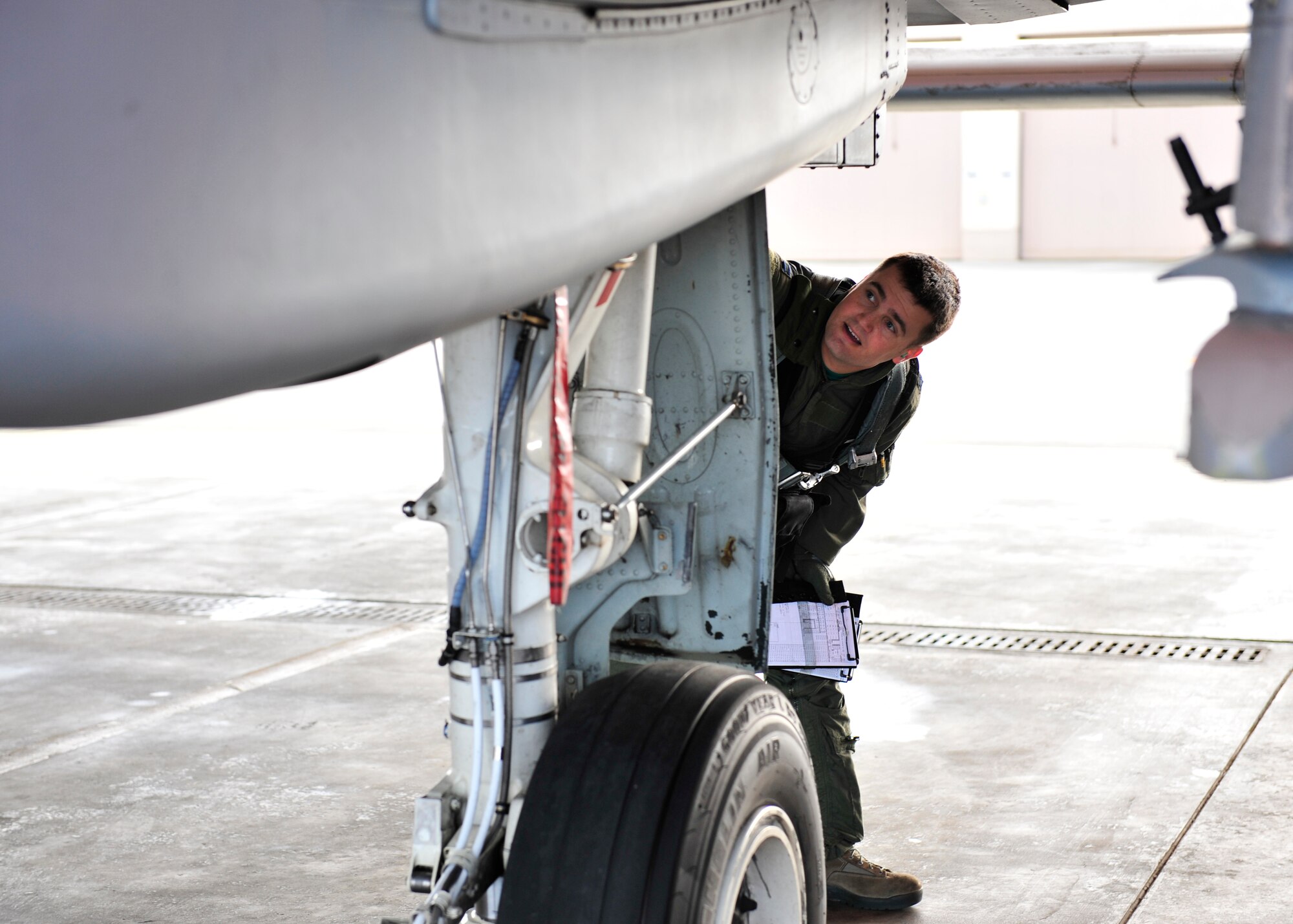 U.S. Air Force Capt. Robert Carpenter, 25th Fighter Squadron pilot assigned to Osan Air Base, South Korea, performs preflight inspections during RED FLAG-Alaska 14-2 June 20, 2014, Eielson Air Force Base, Alaska. RF-A is a multinational, joint exercise that enabled air crew and maintenance units to test their capabilities in a simulated deployed environment. (U.S. Air Force photo by Senior Airman Ashley Nicole Taylor/Released)