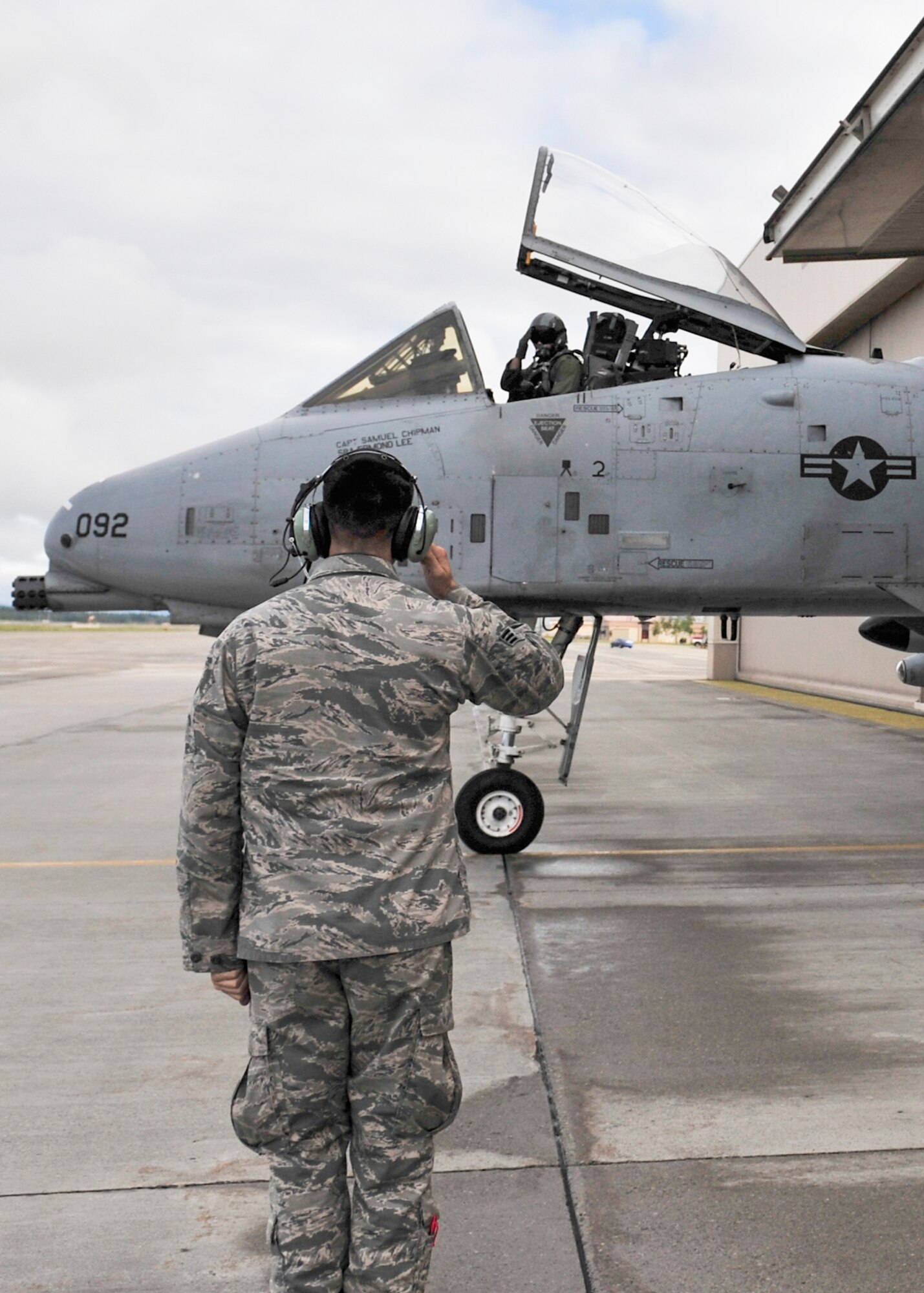 U.S. Air Force Capt. Robert Carpenter, 25th Fighter Squadron pilot and Senior Airman Michael Stedman, 51st Aircraft Maintenance Squadron  crew chief assigned to Osan Air Base, South Korea, salute to each other prior to take off during RED FLAG-Alaska 14-2 June 20, 2014, Eielson Air Force Base, Alaska. During RF-A exercises, participants utilized the Joint Pacific Alaska Range Complex to fly combat situations. (U.S. Air Force photo by Senior Airman Ashley Nicole Taylor/Released)