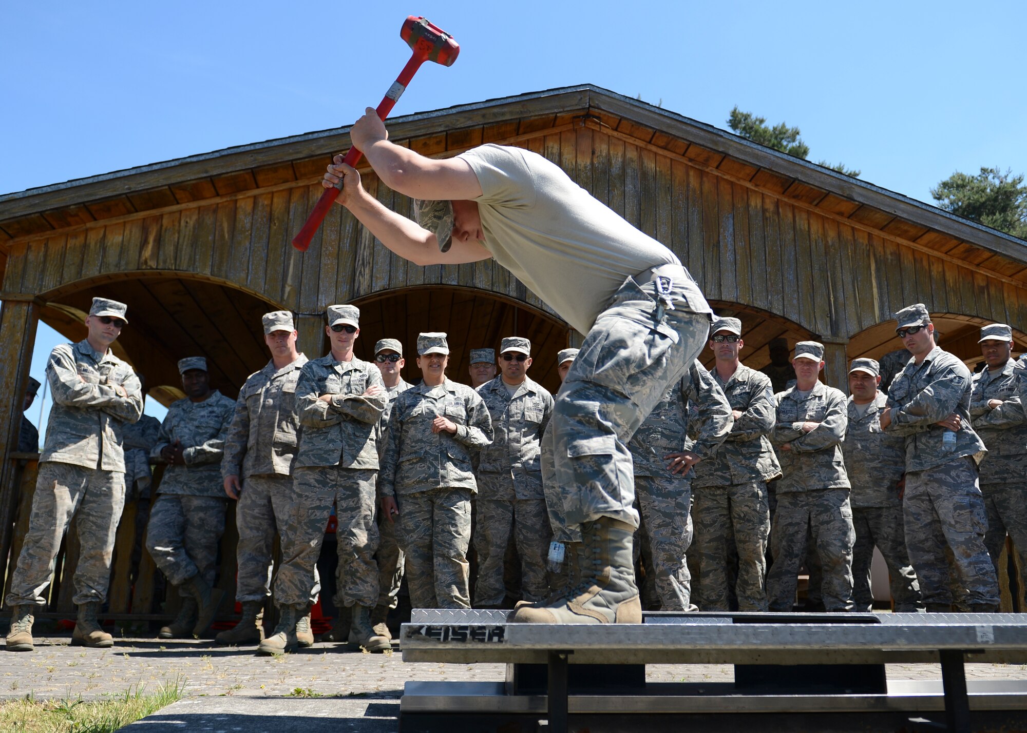 An Airman hits a steel slab with a hammer during a team building exercise during Prime BEEF (Base Engineer Emergency Forces) Day on Ramstein Air Base, Germany, June 13, 2014. The 86th Civil Engineer Squadron conducts Prime BEEF training ensure their Airmen are up to date on deployment essential skills. (U.S. Air Force photo/Airman 1st Class Michael Stuart)
