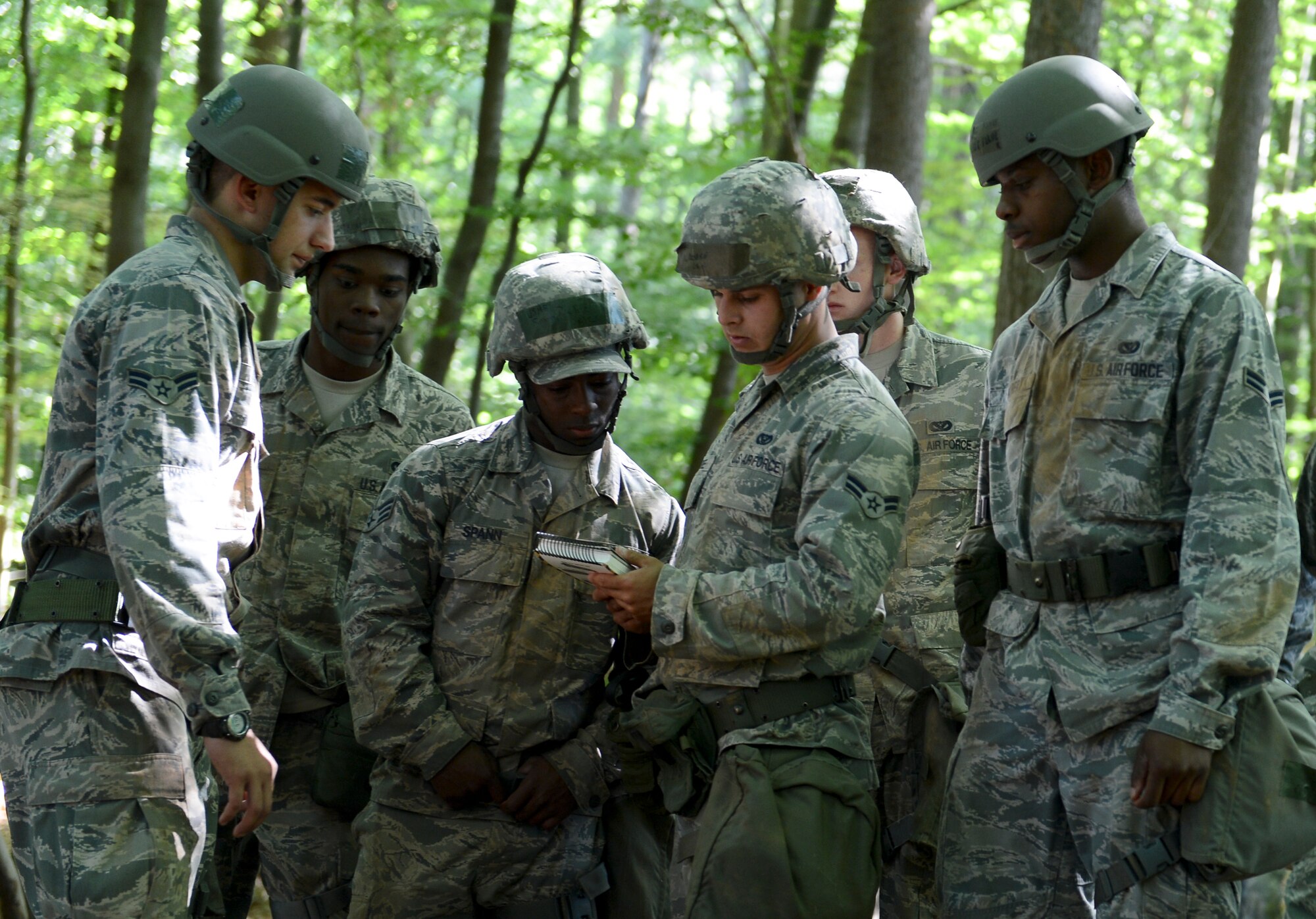 A group of EOD Airmen read an Airman’s manual during a chalk walk through the woods during Prime BEEF (Base Engineer Emergency Forces) Day on Ramstein Air Base, Germany, June 13, 2014. The 86th Civil Engineer Squadron conducts Prime BEEF training ensure their Airmen are up to date on deployment essential skills.   (U.S. Air Force photo/Airman 1st Class Michael Stuart) 