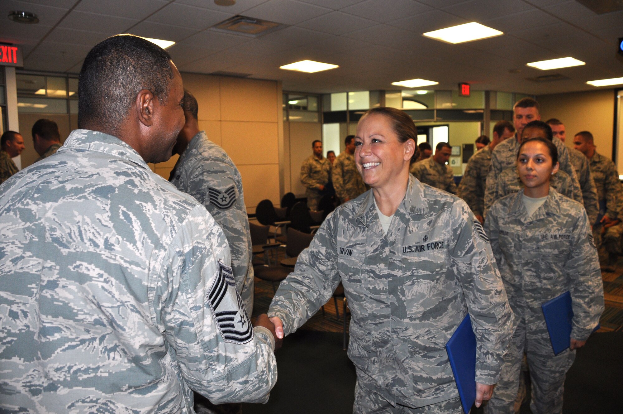 TSgt Andrea Ervin, 927th Aeromedical Staging Squadron, is greeted by Chief Master Sergeant Jim Candler, 927th Force Support Squadron, after completing her two week NCO Leadership and Development course at MacDill. The group of NCOs from the Guard, Reserve, and Active Duty received instruction to prepare them for their new supervisory roles. (U.S. Air Force Photo by Capt. Joe Simms)