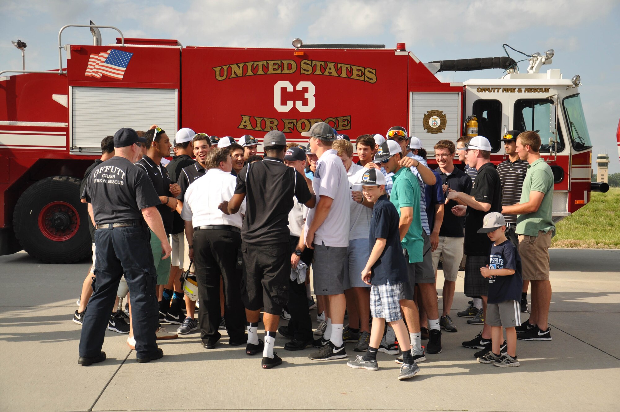 The Vanderbilt University baseball team joins members of the Offutt Air Force Base Fire Emergency Services for a chant at the end of the team’s visit to the fire house on base June 19. The team visited Offutt twice, touring an E-4B, meeting with Security Forces, learning about the Joint POW/MIA command, riding in the fire trucks and eating dinner with Team Offutt members and their families. (U.S. Air Force photo by 2nd Lt. Carly Costello)