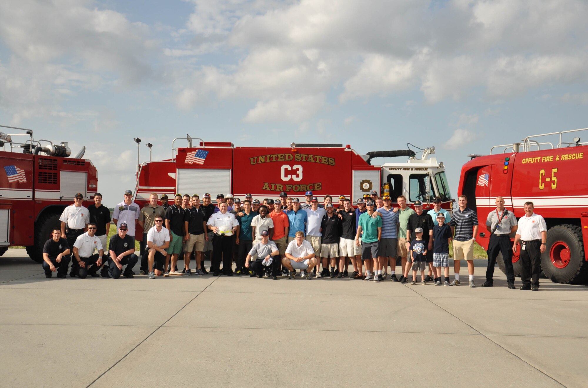 The Vanderbilt University baseball team poses with members the Offutt Air Force Base Fire Emergency Services staff after touring the fire house and learning about the fire trucks June 19 on Offutt Air Force Base. This was the team’s second visit to base during their time in Omaha, Nebraska, for the College World Series. (U.S. Air Force photo by 2nd Lt. Carly Costello)