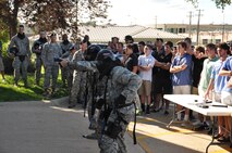Members of the 55th Security Forces Squadron demonstrate their weapons using simulation rounds used for training exercises during a visit by the Vanderbilt University baseball team June 15 at Offutt Air Force Base, Nebraska. (U.S. Air Force photo by 2nd Lt. Carly Costello)