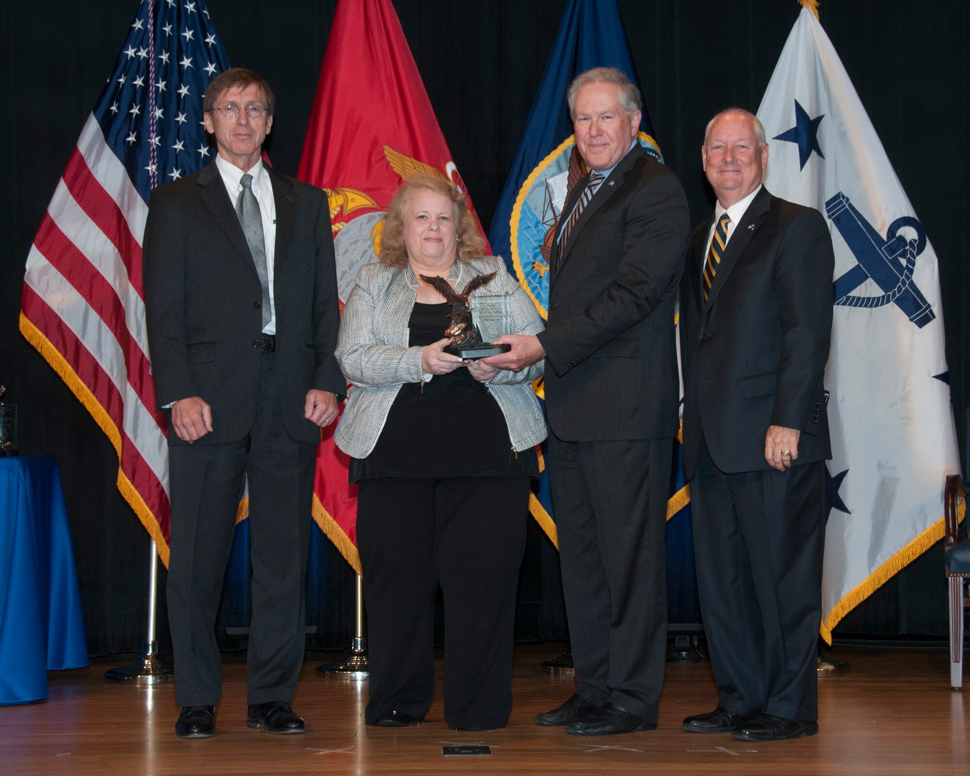 Dawn Chartier, Lakehurst Small Business Office receives the 2013 Sarkis Tatigian Award for acquisition excellence in small business programs within the Department of the Navy from Sean Stackley, Assistant Secretary of the Navy for Research, Development and Acquisition (L) and Frank Kendall, Under Secretary of the Navy for RD&A and Sean Crean, Department of the Navy Director of the Office of Small Business Programs at a ceremony at the Pentagon on June 13.