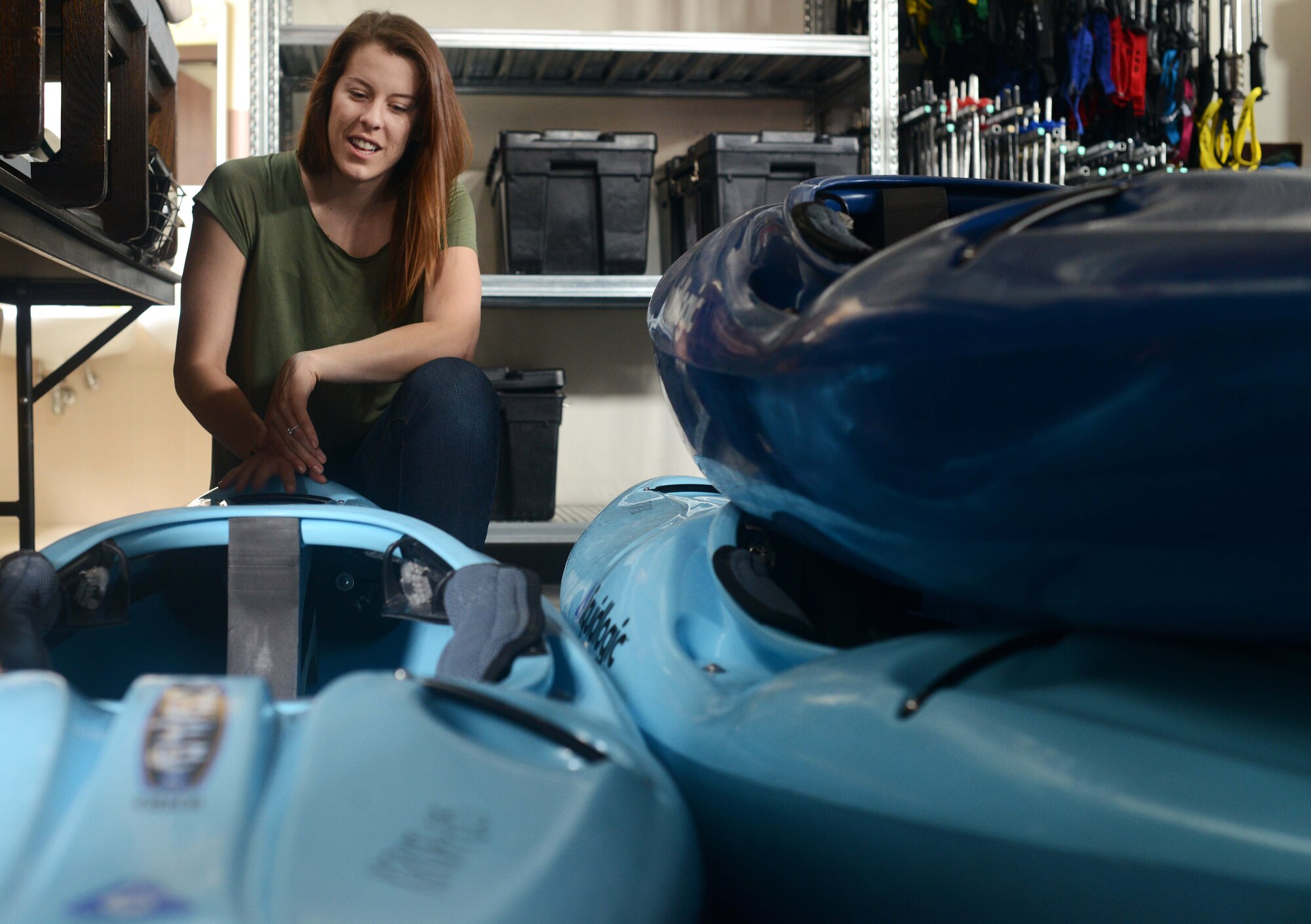 Becky Hughes, 31st Force Support Squadron recreation assistant, prepares kayaks for check-out at outdoor recreation, June 23, 2014, at Aviano Air Base, Italy. ODR offers various outdoor trips, including canyoning and white water rafting in Slovenia throughout the summer.(U.S. Air Force photo/Airman 1st Class Deana Heitzman)    
