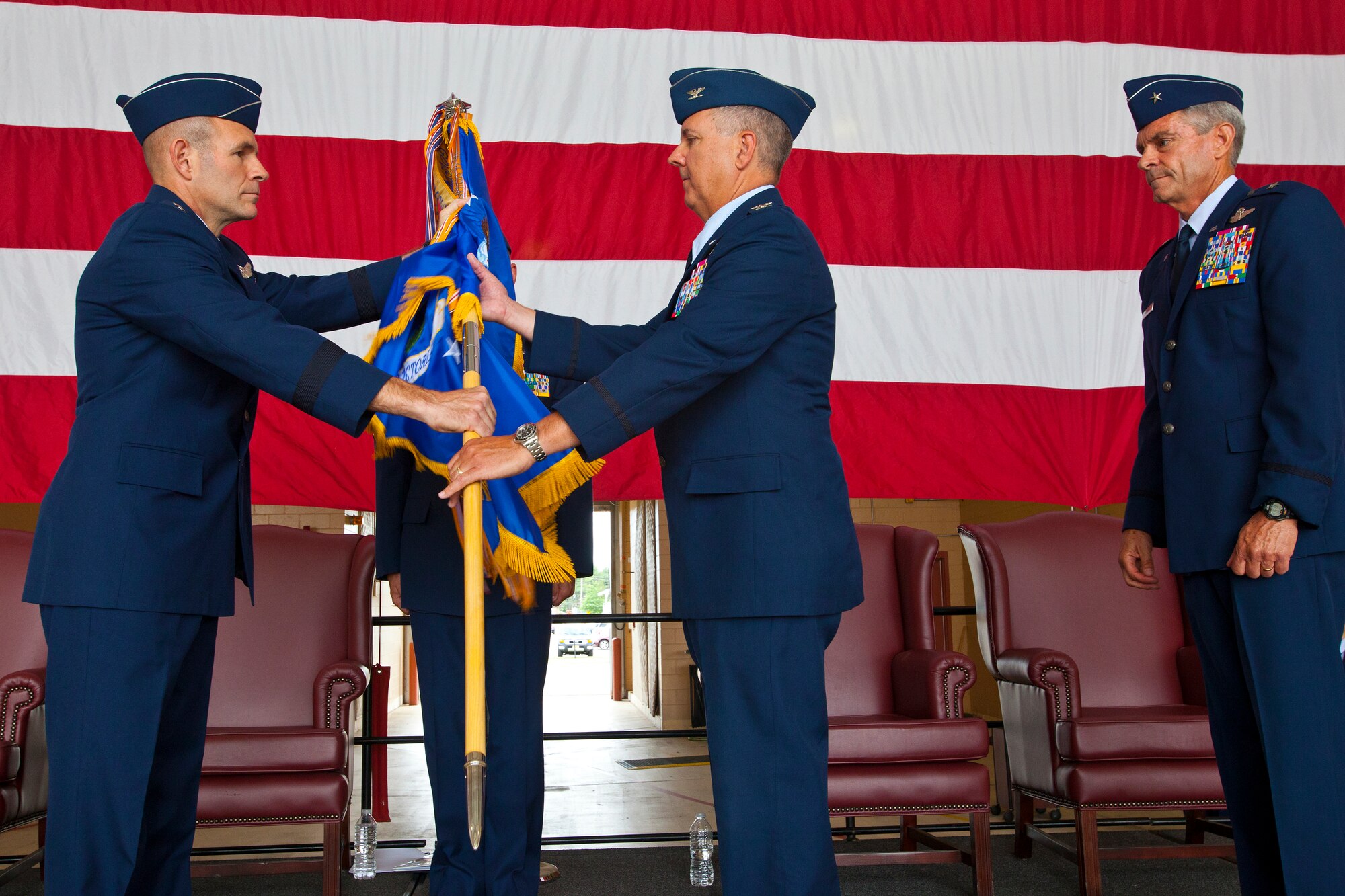 Col. Robert A. Meyer Jr. assumes command of the 108th Wing, New Jersey Air National Guard, from Brig. Gen. Kevin J. Keehn during a Change of Command ceremony at Joint Base McGuire-Dix-Lakehurst, N.J. June 22, 2014.  A change of command ceremony is a military tradition that represents the formal transfer of authority and responsibility for a unit from one commanding or flag officer to another. Since Sept. 11, 2001, the 108th Wing has deployed Airmen around the globe in support of Operation's Iraqi Freedom, Noble Eagle, Enduring Freedom and New Dawn. New Jersey's 21 counties, the homes of the Airmen that serve in the Wing, are represented by the banners hanging from the ceiling. (U.S. Air National Guard photo by Master Sgt. Mark C. Olsen/Released)