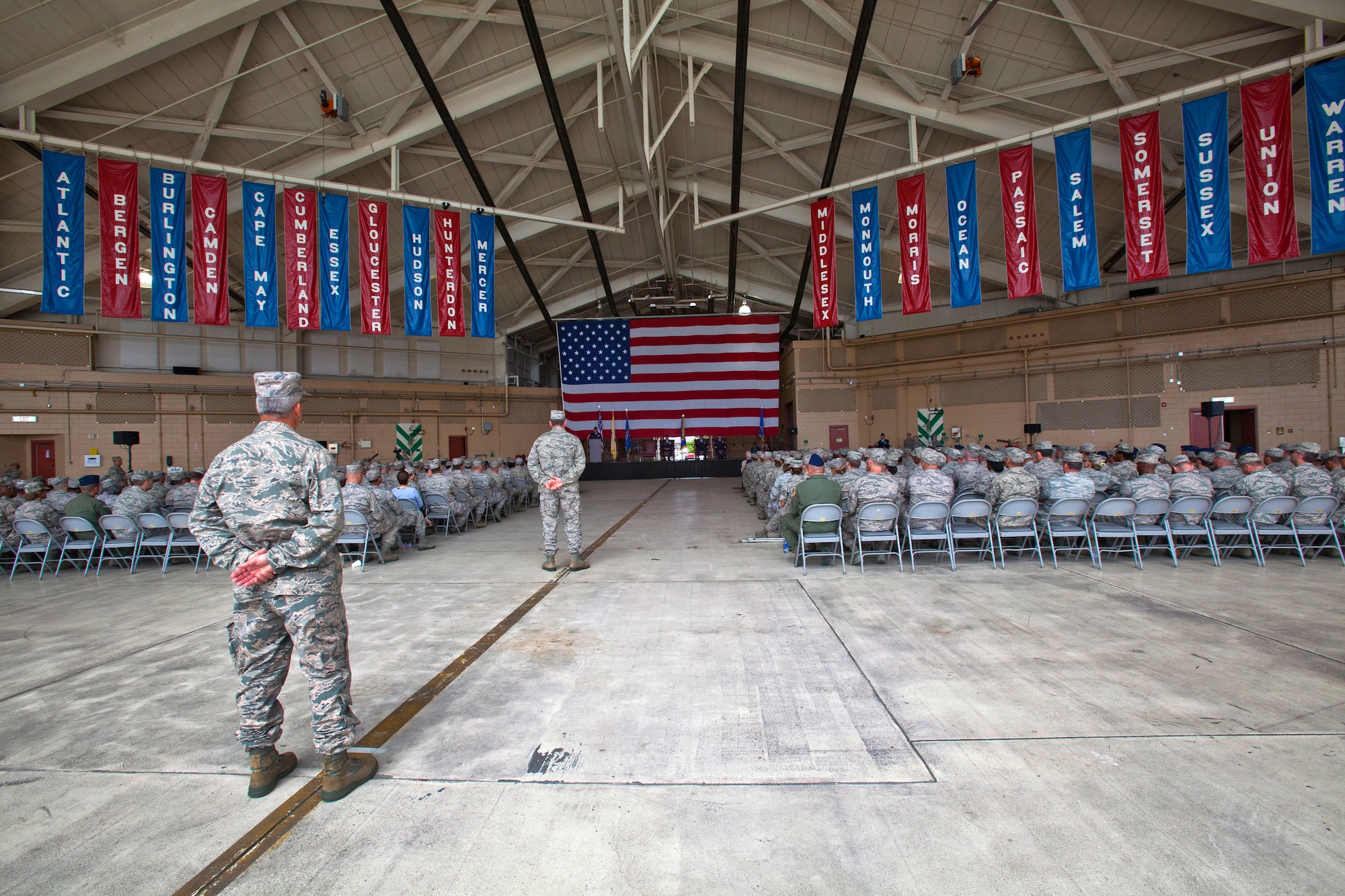Col. Robert A. Meyer Jr. assumes command of the 108th Wing, New Jersey Air National Guard, from Brig. Gen. Kevin J. Keehn during a Change of Command ceremony at Joint Base McGuire-Dix-Lakehurst, N.J. June 22, 2014.  A change of command ceremony is a military tradition that represents the formal transfer of authority and responsibility for a unit from one commanding or flag officer to another. Since Sept. 11, 2001, the 108th Wing has deployed Airmen around the globe in support of Operation's Iraqi Freedom, Noble Eagle, Enduring Freedom and New Dawn. New Jersey's 21 counties, the homes of the Airmen that serve in the Wing, are represented by the banners hanging from the ceiling. (U.S. Air National Guard photo by Master Sgt. Mark C. Olsen/Released)