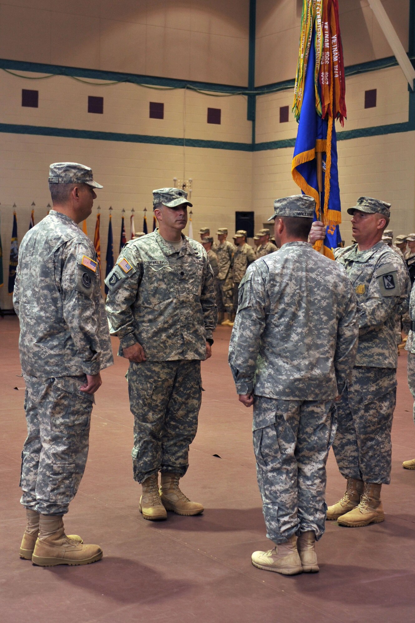 From left, U.S. Army Col. Julius A. Rigole, 128th Aviation Brigade commander, Lt. Col. Christopher M. Stallings, 1st Battalion, 222nd Aviation Regiment incoming commander, Lt. Col. Michael R. Williams, 1-222nd Avn. Reg. outgoing commander, and Sgt. Maj. Russell Merchant, 1-222nd Avn. Reg. sergeant major, prepare to exchange the unit colors during the 1-222nd Avn. Reg. change of command ceremony at Fort Eustis, Va., June 20, 2014.  The 1-222nd Aviation Regiment’s mission is to continuously conduct advanced individual training to ensure students’ transition to the operational Army immediately contributes to combat readiness. (U.S. Air Force photo by Staff Sgt. Katie Gar Ward/Released)