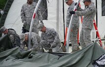 The 5th Civil Engineer Squadron conducted deployment training at Minot Air Force Base, N.D., June 18, 2014. Airmen from all ranks participated in training that taught them how to build a tent together, conduct a proper convoy and how to use some of the large mobile equipment used in a deployed environment. (U.S. Air Force photo/Senior Airman Andrew Crawford)
