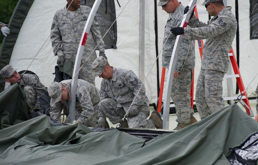 The 5th Civil Engineer Squadron conducted deployment training at Minot Air Force Base, N.D., June 18, 2014. Airmen from all ranks participated in training that taught them how to build a tent together, conduct a proper convoy and how to use some of the large mobile equipment used in a deployed environment. (U.S. Air Force photo/Senior Airman Andrew Crawford)