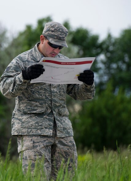 The 5th Civil Engineer Squadron conducted deployment training at Minot Air Force Base, N.D., June 18, 2014. Airmen from all ranks participated in training that taught them how to build a tent together, conduct a proper convoy and how to use some of the large mobile equipment used in a deployed environment. (U.S. Air Force photo/Senior Airman Andrew Crawford)