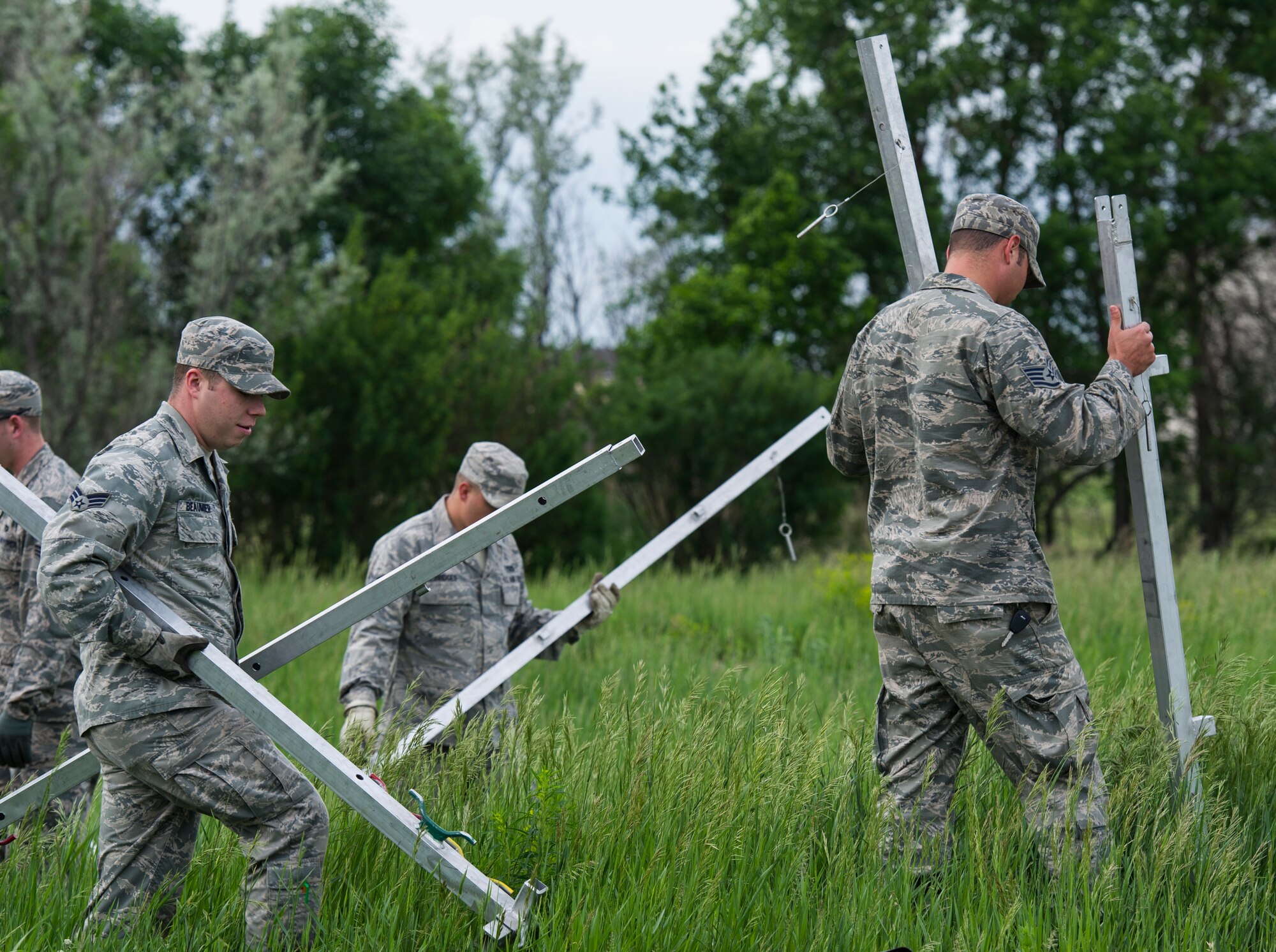 The 5th Civil Engineer Squadron conducted deployment training at Minot Air Force Base, N.D., June 18, 2014. Airmen from all ranks participated in training that taught them how to build a tent together, conduct a proper convoy and how to use some of the large mobile equipment used in a deployed environment. (U.S. Air Force photo/Senior Airman Andrew Crawford)