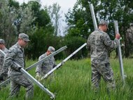 The 5th Civil Engineer Squadron conducted deployment training at Minot Air Force Base, N.D., June 18, 2014. Airmen from all ranks participated in training that taught them how to build a tent together, conduct a proper convoy and how to use some of the large mobile equipment used in a deployed environment. (U.S. Air Force photo/Senior Airman Andrew Crawford)