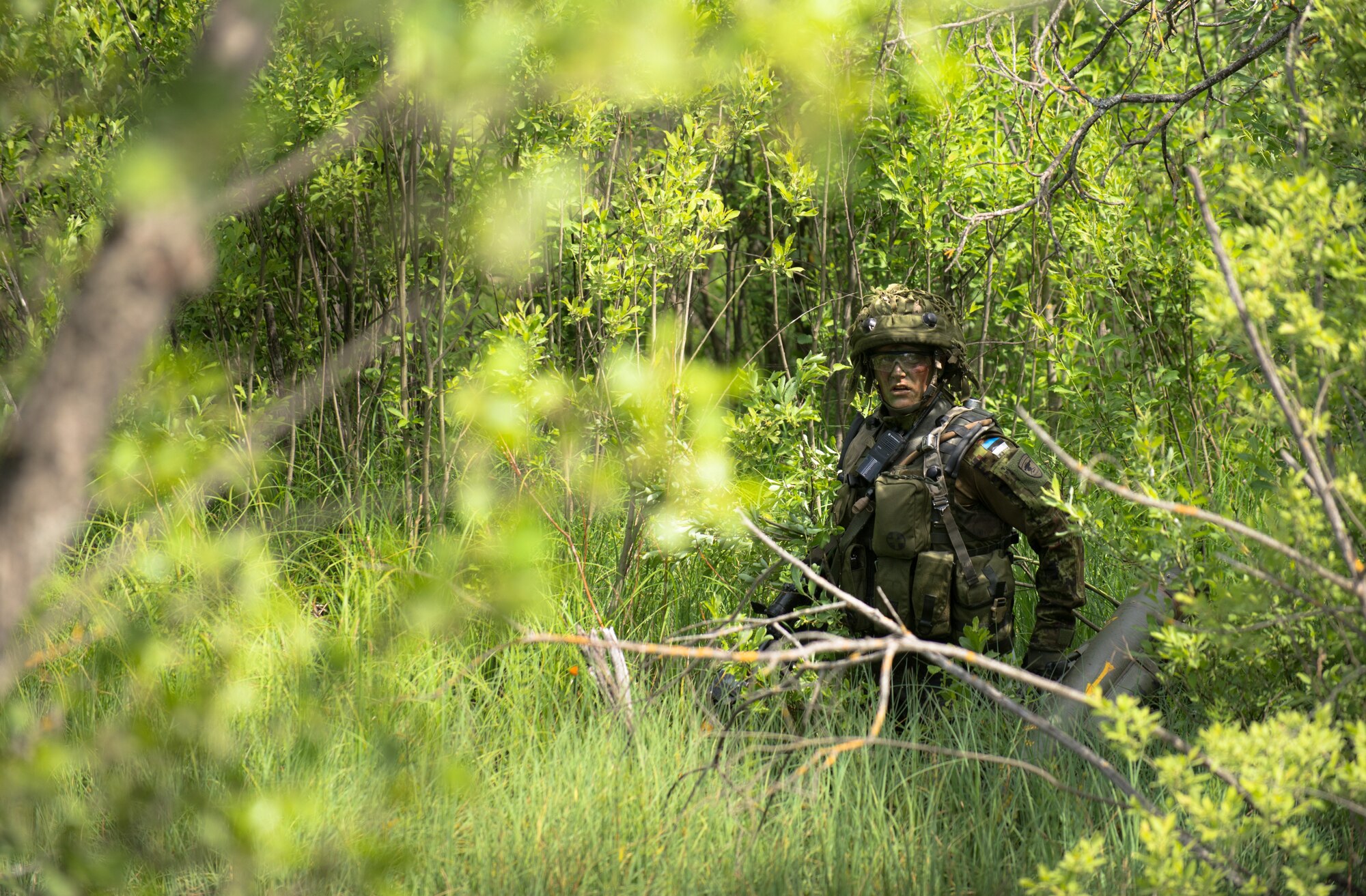 An Estonian soldier looks for cover during a Saber Strike exercise in the Adazi Training Area, Latvia, June 11, 2014. The exercise focused on conducting a counter attack with approximately 140 Estonian soldiers against the U.S. Army with Air National Guard assets. (U.S. Air Force photo/Senior Airman Jonathan Stefanko)