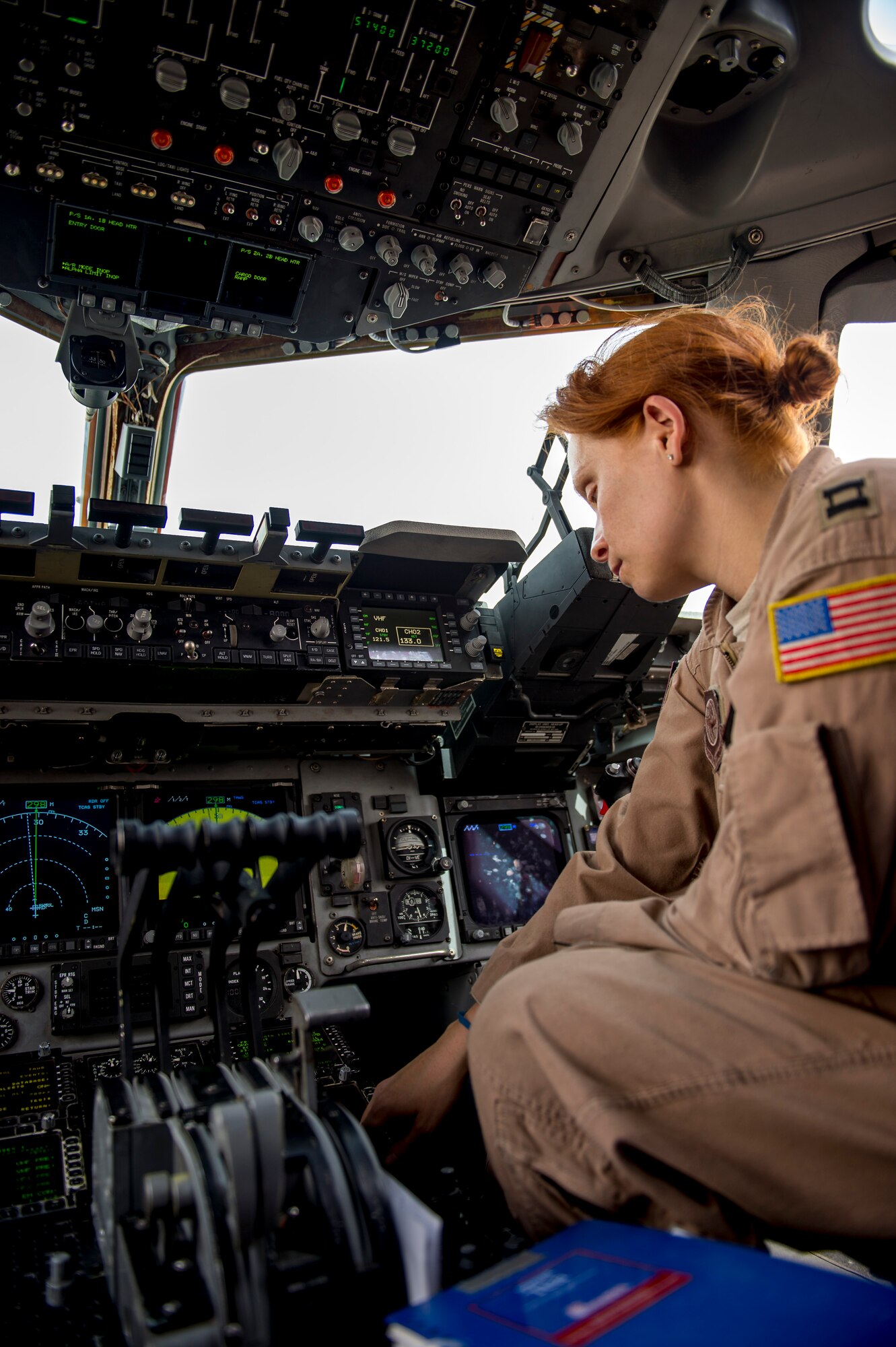 Capt. Jennifer Moore, 816th Air Expeditionary Squadron pilot assigned to the 385th Air Expeditionary Group Det. 1, runs through pre-flight checks on a C-17 Globemaster III June 23, 2014 at an undisclosed location in Southwest Asia. Moore is deployed from the 8th Airlift Squadron, McChord Air Force Base, Wash. in support of Operation Enduring Freedom and is a native of New Hyde Park, N.Y. (U.S. Air Force photo by Staff Sgt. Jeremy Bowcock)