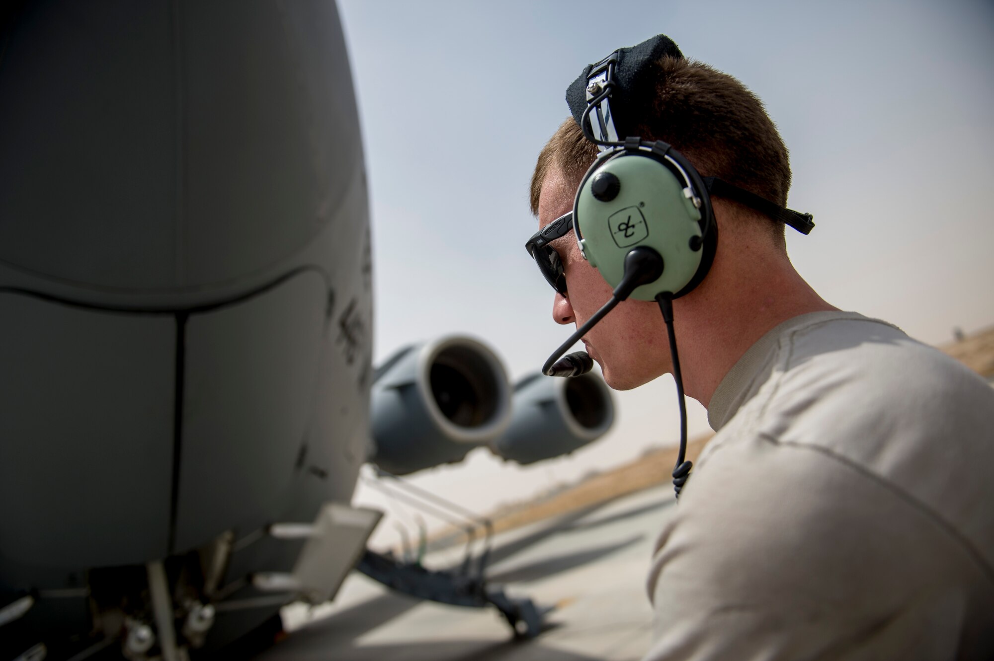 U.S. Air Force Senior Airman Wade Clark, 5th Expeditionary Aircraft Mobility Squadron, watches a C-17 Globemaster III as its being refueled to ensure it does not overflow June 23, 2014 at an undisclosed location in Southwest Asia. Clark is deployed from Travis Air Force Base, Calif. in support of Operation Enduring Freedom and a native of Pleasant Hill, Ore. (U.S. Air Force photo by Staff Sgt. Jeremy Bowcock)