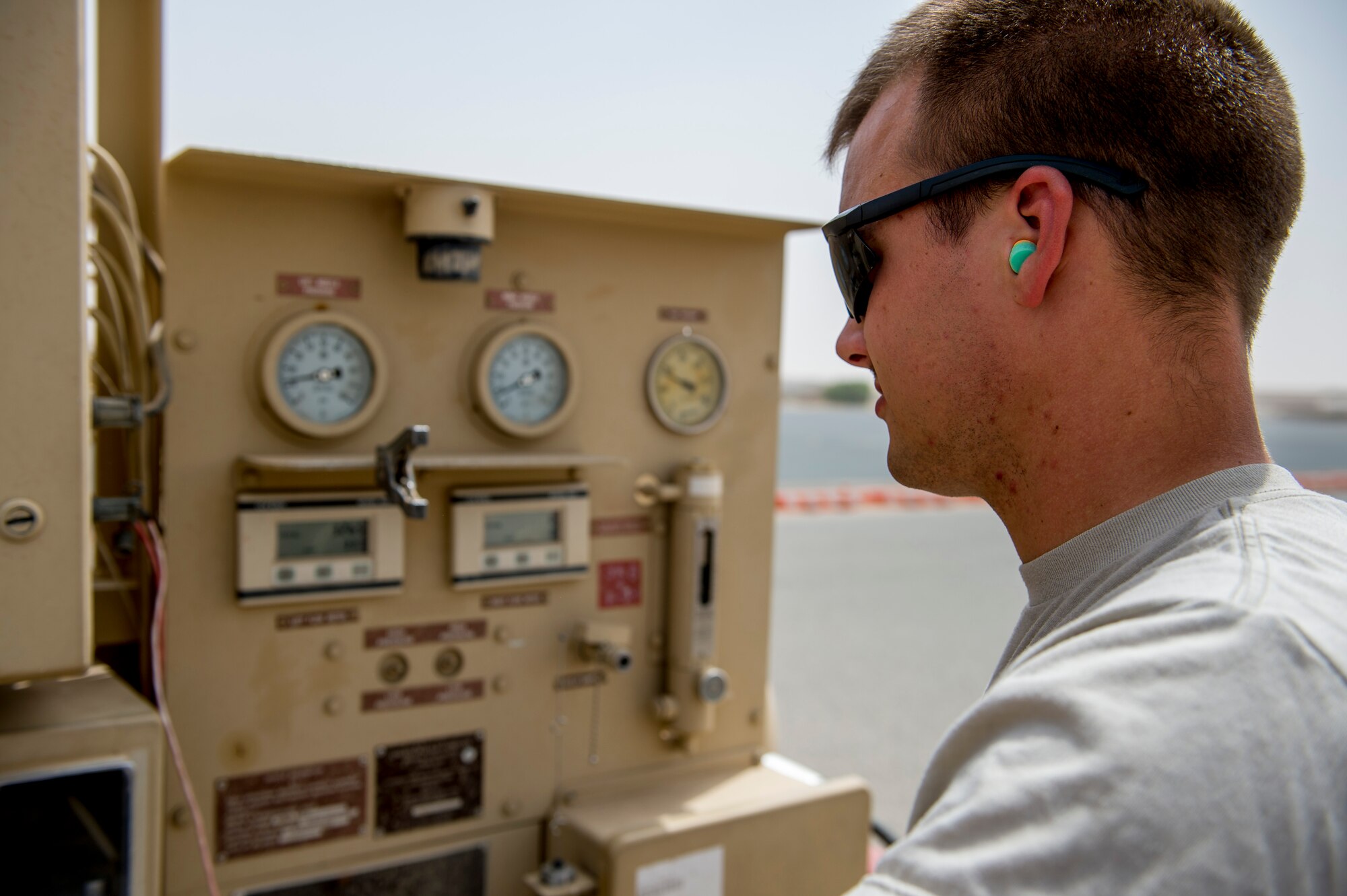 U.S. Air Force Senior Airman Kevin Becker, 386th Expeditionary Logistics Readiness Squadron fuels distributor, watches gauges as he refuels a C-17 Globemaster III June 23, 2014 at an undisclosed location in Southwest Asia. Becker is deployed from the 6th LRS at MacDill Air Force Base, Fla. in support of Operation Enduring Freedom and a native of Sioux Falls, N.D. (U.S. Air Force photo by Staff Sgt. Jeremy Bowcock)
