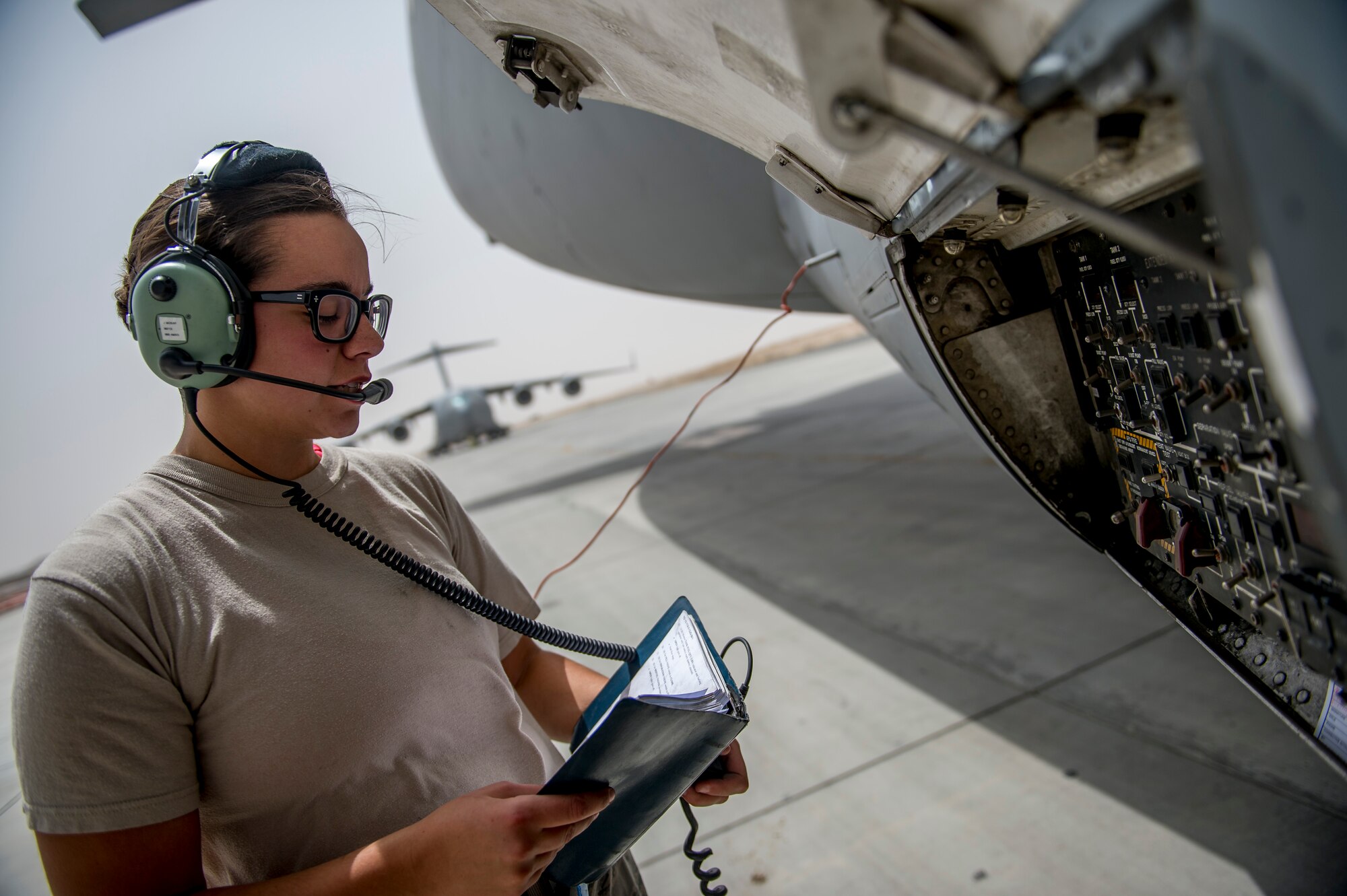 U.S. Air Force Airman 1st Class Jessica McKay, 5th Expeditionary Aircraft Mobility Squadron, checks fuel levels during refueling operations on a C-17 Globemaster III June 23, 2014 at an undisclosed location in Southwest Asia. McKay is deployed from Travis Air Force Base, Calif. in support of Operation Enduring Freedom and a native of Puyallup, Wash. (U.S. Air Force photo by Staff Sgt. Jeremy Bowcock)