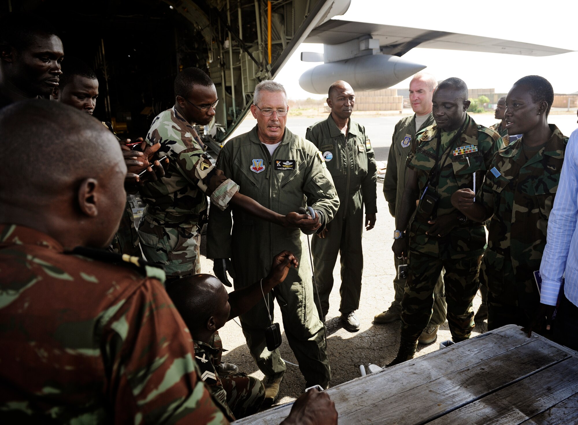 Chief Master Sgt. Bill Wunderlin 130th Rescue Wing loadmaster, demonstrates how to hook up a winch during the U.S. Air Forces in Europe and Air Forces Africa lead African Partnership Flight in Dakar, Senegal, June 19, 2014. USAFE-AFAFRICA Airmen are in Senegal for APF, a program designed to improve communication and interoperabilty between regional partners in Africa. The African partners include Senegal, Togo, Burkina Faso, Benin, Ghana, Mauritania, Nigeria and Niger with the U.S. facilitating the program. (U.S. Air Force photo/ Staff Sgt. Ryan Crane)