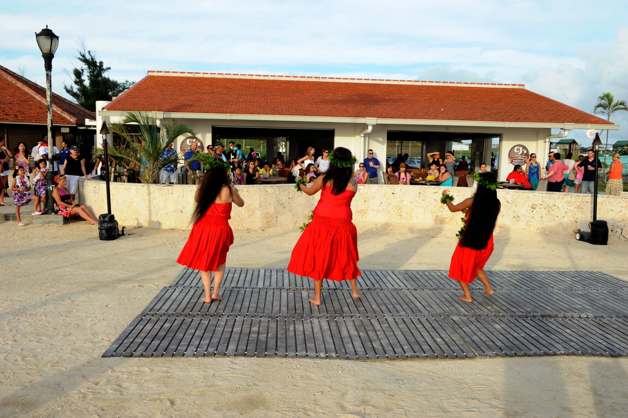 Okinawa's Hui Nohona Aloha dance group performs an array of hula dances during the Deployed Spouses Luau on Torii Beach, Japan, June 21, 2014. The luau was open to all branches of the military and was hosted by Army Community Service on Torii Station and the Airman and Family Readiness Center on Kadena Air Base. More than 170 people attended the luau. (U.S. Air Force photo by Airman 1st Class Stephen G. Eigel)