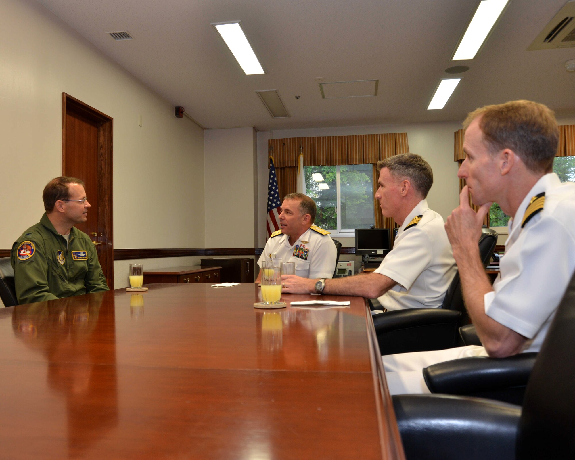 Rear Adm. Terry Kraft, U.S. Naval Forces Japan commander, center, meets with Col. Stephen Williams, 35th Fighter Wing commander, left, during an office visit along with Capt. Chris Rodeman, Naval Air Facility Misawa commanding officer, center-right, and Capt. Keith Henry, far right, NAF Misawa prospective commanding officer, June 19, 2014. Kraft is currently visiting NAF Misawa, and visiting with installation leadership. He'll also take part in the NAF Misawa Change of Command Ceremony, June 20. (U.S. Navy photo by Mass Communication Specialist 3rd Class Erin Devenberg/Released)