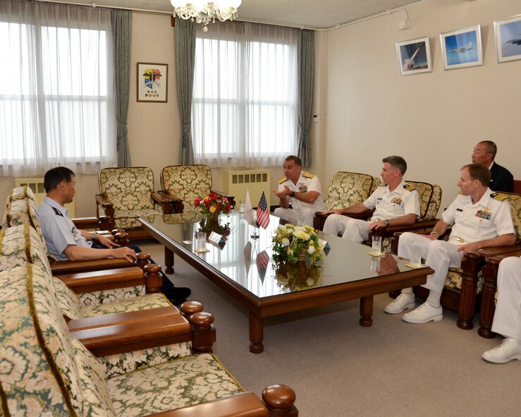 Rear Adm. Terry Kraft, U.S. Naval Forces Japan commander, right, meets with Lt. Gen. Tetsuo Morimoto, Northern Air Defense Force commander, left, during an office visit with Capt. Chris Rodeman, center-right, Naval Air Facility Misawa commanding officer, and Capt. Keith Henry, NAF Misawa prospective commanding officer, June 19, 2014. Kraft is currently visiting NAF Misawa, and meeting with local and military Japanese national officials. He'll also take part in the NAF Misawa Change of Command Ceremony, June 20. (U.S. Navy photo by Mass Communication Specialist 3rd Class Erin Devenberg/Released)