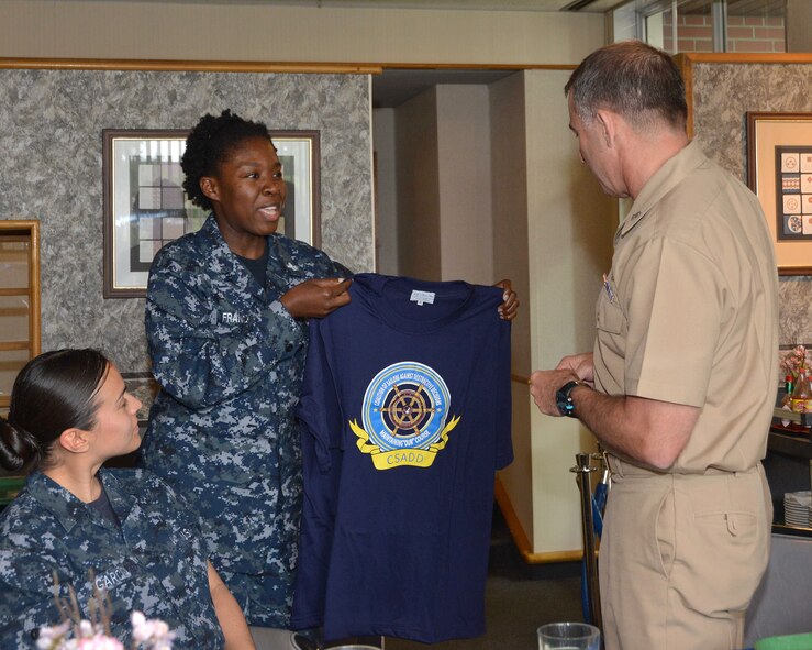 Aviation Support Equipment Technician 2nd Class Klaus Franck, center, originally from San Diego, and a member of the Coalition of Sailors Against Destructive Decisions (CSADD) Misawa, presents a CSADD t-shirt to Rear Adm. Terry Kraft, U.S. Naval Forces Japan commander, during a luncheon, June 19, 2014. Kraft is currently visiting NAF Misawa, meeting with Sailors, and touring installation’s facilities. He'll also take part in the NAF Misawa Change of Command Ceremony, June 20. (U.S. Navy photo by Mass Communication Specialist 3rd Class Erin Devenberg/Released)