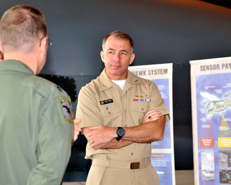 Rear Adm. Terry Kraft, U.S. Naval Forces Japan commander, listens as 69th Reconnaissance Group Detachment 1 leadership explains some of the capabilities of the RQ-4 Global Hawk unmanned aerial vehicle (UAV) surveillance aircraft, June 19, 2014. Kraft is currently visiting NAF Misawa, and is using the opportunity to meet with Sailors, and to inspect the installation’s various facilities. (U.S. Navy photo by Senior Chief Mass Communication Specialist Daniel Sanford/Released)