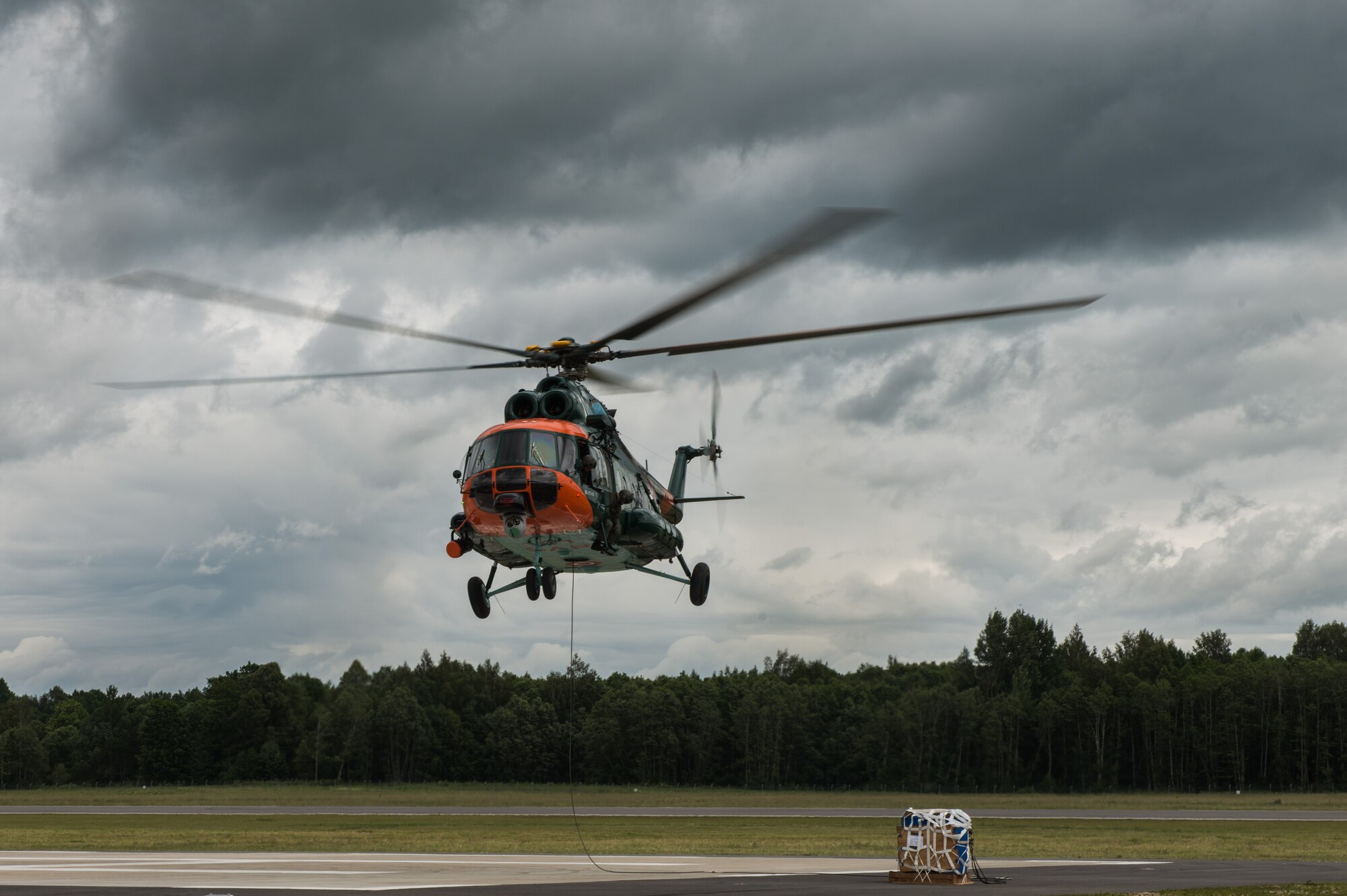 A Latvian Mi-8 lowers a bundle in part of sling-load operations training with Airmen from the 435th Contingency Response Group during the Air Force-specific portion of Saber Strike at Lielvarde Air Base, Latvia, June 17, 2014. During the final week of Saber Strike 2014 the 435th CRG, in conjunction with the 37th Airlift Squadron, trained on the full capabilities to open the Latvian air base. They also trained with Latvian and Estonian service members on airfield operations, command and control of air and space forces, weather support, and protection of operational forces, aircraft maintenance and aerial port services. (U.S. Air Force photo/Senior Airman Jonathan Stefanko)