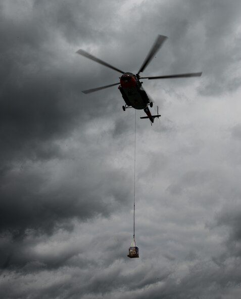 A Latvian Mi-8 helicopter flies off after Airmen from the 435th Contingency Response Group attach a bundle in part of sling-load operations training during the Air Force-specific portion of Saber Strike at Lielvarde Air Base, Latvia, June 17, 2014. During the final week of Saber Strike 2014 the 435th CRG, in conjunction with the 37th Airlift Squadron, trained on the full capabilities to open the Latvian air base. They also trained with Latvian and Estonian service members on airfield operations, command and control of air and space forces, weather support, and protection of operational forces, aircraft maintenance and aerial port services. (U.S. Air Force photo/Senior Airman Jonathan Stefanko)