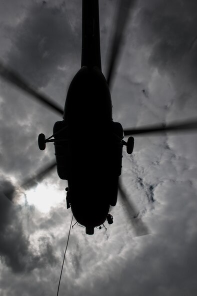 A Latvian Mi-8 helicopter prepares to fly off after Airmen from the 435th Contingency Response Group attach a bundle in part of sling-load operations training during the Air Force-specific portion of Saber Strike at Lielvarde Air Base, Latvia, June 17, 2014. During the final week of Saber Strike 2014 the 435th CRG, in conjunction with the 37th Airlift Squadron, trained on the full capabilities to open the Latvian air base. They also trained with Latvian and Estonian service members on airfield operations, command and control of air and space forces, weather support, and protection of operational forces, aircraft maintenance and aerial port services. (U.S. Air Force photo/Senior Airman Jonathan Stefanko)