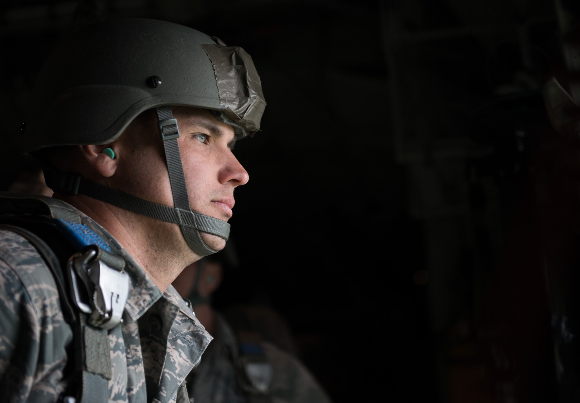 An Airman from the 435th Contingency Response Group, waits to jump out of a C-130 J-model door during the Air Force-specific portion of Saber Strike at Lielvarde Air Base, Latvia, June 17, 2014. During the final week of Saber Strike 2014 the 435th CRG, in conjunction with the 37th Airlift Squadron, trained on the full capabilities to open the Latvian air base. They also trained with Latvian and Estonian service members on airfield operations, command and control of air and space forces, weather support, and protection of operational forces, aircraft maintenance and aerial port services. (U.S. Air Force photo/Senior Airman Jonathan Stefanko)