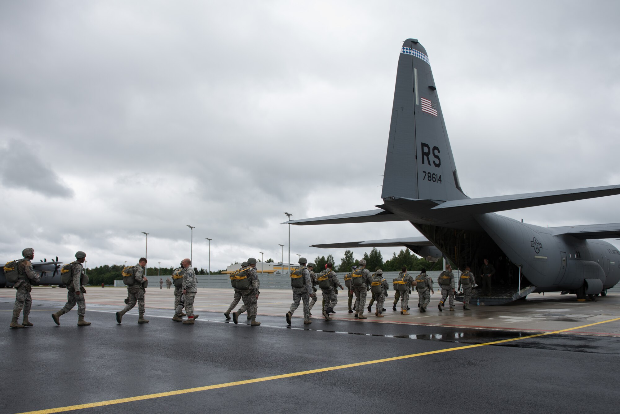 Airmen from the 435 Contingency Response Group and Estonian military members board a C-130 J-model for parachute training during the Air Force-specific portion of Saber Strike at Lielvarde Air Base, Latvia, June 18, 2014. During the final week of Saber Strike 2014 the 435th Contingency Response Group, in conjunction with the 37th Airlift Squadron, trained on the full capabilities to open the Latvian air base. They also trained with Latvian and Estonian service members on airfield operations, command and control of air and space forces, weather support, and protection of operational forces, aircraft maintenance and aerial port services. (U.S. Air Force photo/Senior Airman Jonathan Stefanko)
