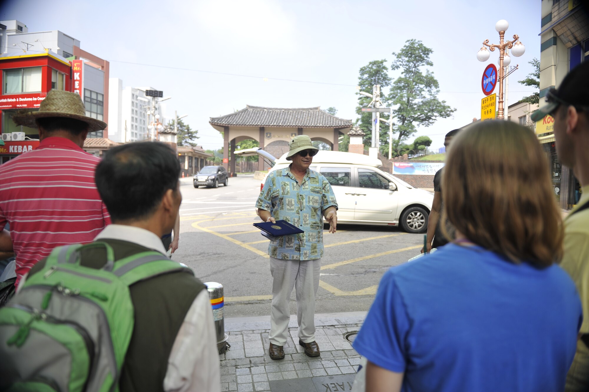 Jim Dunnett, Korean American Partnership Association outreach coordinator, talks to service members and civilians prior to starting a Troops for Trash event in the Songtan Entertainment District, Republic of Korea, June 14, 2014. KAPA’s purpose is to strengthen the Korean and American alliance through participation in joint activities. (U.S. Air Force photo/Senior Airman David Owsianka) 