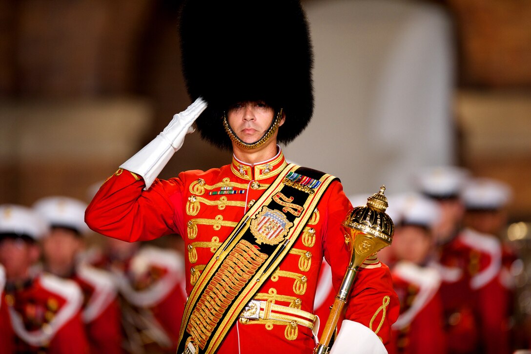 A U.S. Marine Band drum major salutes after marching to his position