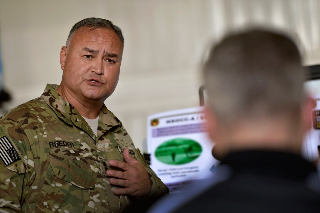 U.S. Deputy Defense Secretary Bob Work receives a briefing by U.S. Army Maj. Gen. Edward Reeder Jr., left, commander of NATO Special Operations Component Command-Afghanistan and Special Operations Joint Task Force-Afghanistan, on his unit's cooperative mission with Afghan forces in Kabul, Afghanistan, June 22, 2014.