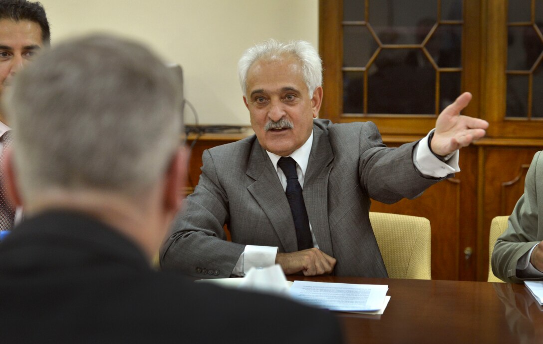 Afghan National Security Adviser Rangin Dadfar Spanta gestures toward members of his staff as he welcomes U.S. Deputy Defense Secretary Bob Work to a meeting at the Afghan presidential palace in Kabul, Afghanistan, June 23, 2014.
