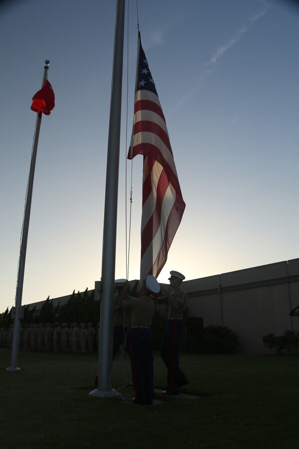 The flag is lowered during an evening colors ceremony aboard Marine Corps Air Station Miramar, Calif., June 23. Cpl. William “Kyle” Carpenter, Medal of Honor recipient, attended the ceremony as the guest of honor and spoke about the impact noncommissioned officers can make on junior Marines.