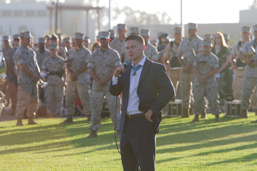 Marine Cpl. William “Kyle” Carpenter, recent Medal of Honor recipient, addresses a crowd aboard Marine Corps Air Station Miramar, Calif., during an evening colors ceremony, June 23. The Marines of the 3rd Marine Aircraft Wing and MCAS Miramar recognized the spirit of the noncommissioned officer to pay tribute to the sacrifices of Carpenter, the most recent Medal of Honor recipient. On June 19, 2014, Carpenter joined the ranks of Medal of Honor recipients for conspicuous gallantry at the risk of his life while serving as a squad automatic rifleman with Company F, 2nd Battalion, 9th Marines, Regimental Combat Team 1, I Marine Expeditionary Force (Forward), Nov. 21, 2010 in Marjah District, Helmand Province, Afghanistan. As a lance corporal, Carpenter risked life and limb to shield his fellow Marine when a hand grenade detonated in their sandbagged position.

