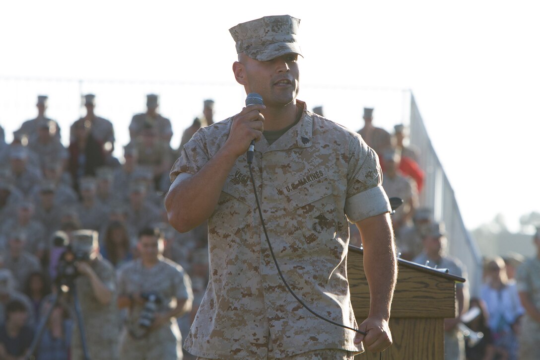 Sgt. Julio C. Vegaflores, the reviewing officer for the event and an instructor with Marine Corps Air Station Miramar Corporals Course, addresses the crowd during an evening colors ceremony, June 23. The ceremony featured Cpl. William “Kyle” Carpenter, recent Medal of Honor recipient and recognized the spirit and dedication of the Marine noncommissioned officer.