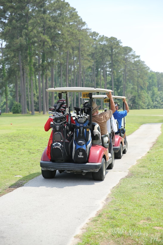A team of golfers travel to the next hole while participating in the Commanding Officer’s Spring Invitational Golf Tournament at the Sound of Freedom Golf Course at Marine Corps Air Station Cherry Point June 10, 2014. Nearly 50 golfers participated in the mixed-format game for a chance to win a variety of prizes.


