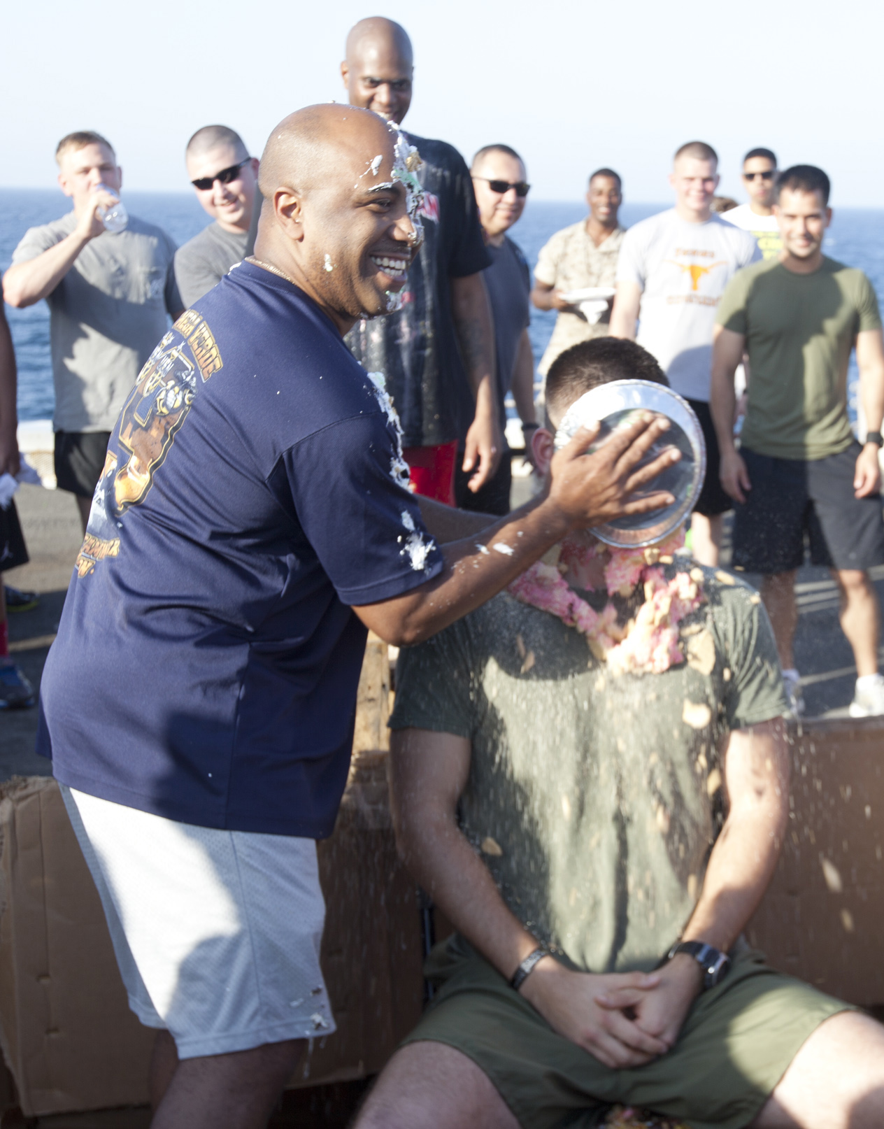 ARABIAN GULF (Jun. 18, 2014) U.S. Marine Corps Gunnery Sgt. Cory Thomas, left, Combat Logistics Battalion (CLB) 22, 22nd Marine Expeditionary Unit (MEU), communications chief and native of South Hill, Va., smashes a pie into the face of 1st Lt. Victor Szeligowski, CLB-22 communications officer and native of Newark, Ill., as part of a fundraiser to benefit a Marine Corps birthday ball, during a “Half-Way Day” celebration aboard the USS Mesa Verde (LPD 19) to mark the approximate middle of the current deployment. The 22nd MEU is deployed with the Bataan Amphibious Ready Group as a theater reserve and crisis response force throughout U.S. Central Command and the U.S. 5th Fleet area of responsibility. (U.S. Marine Corps photo by Staff Sgt. Lukas Atwell/Released)