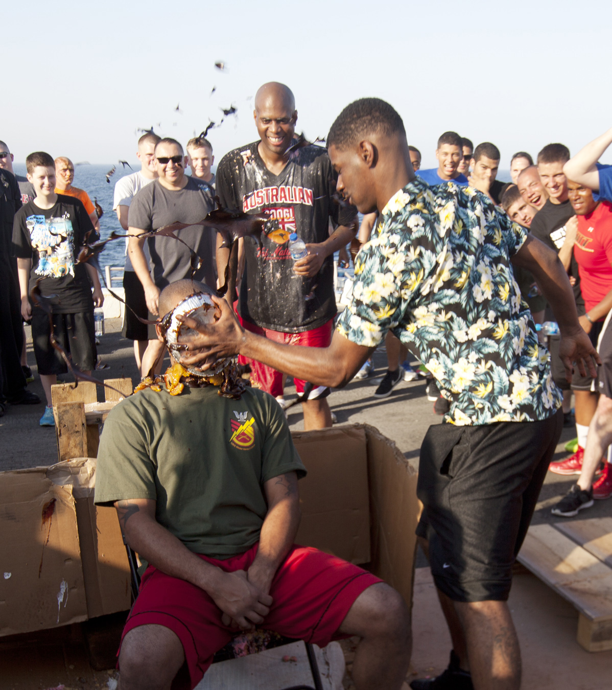 ARABIAN GULF (Jun. 18, 2014) U.S. Marine Corps Cpl. Craig Jenkins, right, Combat Logistics Battalion (CLB) 22, 22nd Marine Expeditionary Unit (MEU), food service specialist and New Orleans native, smashes a pie into the face of Staff Sgt. Emanuel Burton, CLB-22 mess chief and Cleveland native, as part of a fundraiser to benefit a Marine Corps birthday ball, during a “Half-Way Day” celebration aboard the USS Mesa Verde (LPD 19) to mark the approximate middle of the current deployment. The 22nd MEU is deployed with the Bataan Amphibious Ready Group as a theater reserve and crisis response force throughout U.S. Central Command and the U.S. 5th Fleet area of responsibility. (U.S. Marine Corps photo by Staff Sgt. Lukas Atwell/Released)
