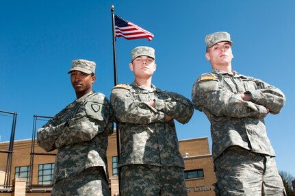 Army Pfc. David Huff, Army Pvt. Tylor Dolfi, and Army Pvt. Evan Dancer, stand proudly in front of the National Guard Patriot Academy at the Muscatatuck Urban Training Center, Ind., Feb. 17, 2012. The three Alaska Army National Guard members are attending the National Guard Patriot Academy and are currently on track to earn their high school diplomas by the end of the summer.