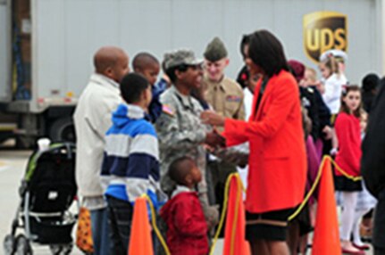 First Lady Michelle Obama arrives at Raleigh-Durham International Airport where she greeted active duty, National Guard and veteran service members along with their families from all branches of the military here, March 2, 2012. Here Obama talks to North Carolina Army National Guard Staff Sgt. Stacy Gardner and her family.